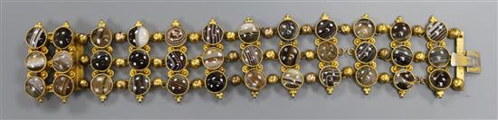An ornate Victorian pinchbeck and triple row banded agate bracelet, set with thirty six stones, approx. 17cm.